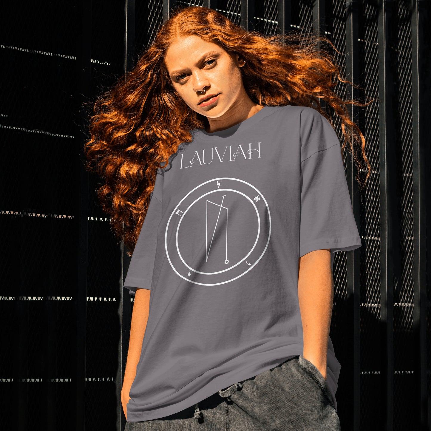 Model wearing No.17 Lauviah Shem Hamephorash Guardian Angel T-Shirt in charcoal with symbol of Lauviah on front