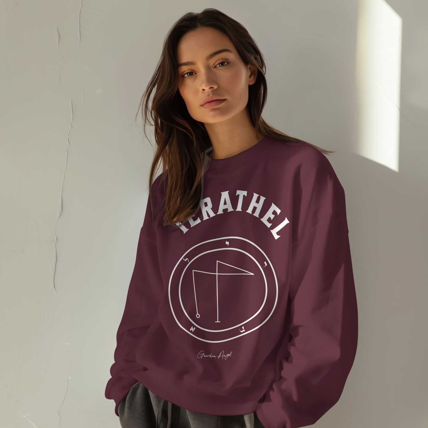 Model wearing a No.27 Shemhamphorasch Guardian Angel "Ierathel" Sweatshirt in Maroon. With the seal of Ierathel in white print on the front.