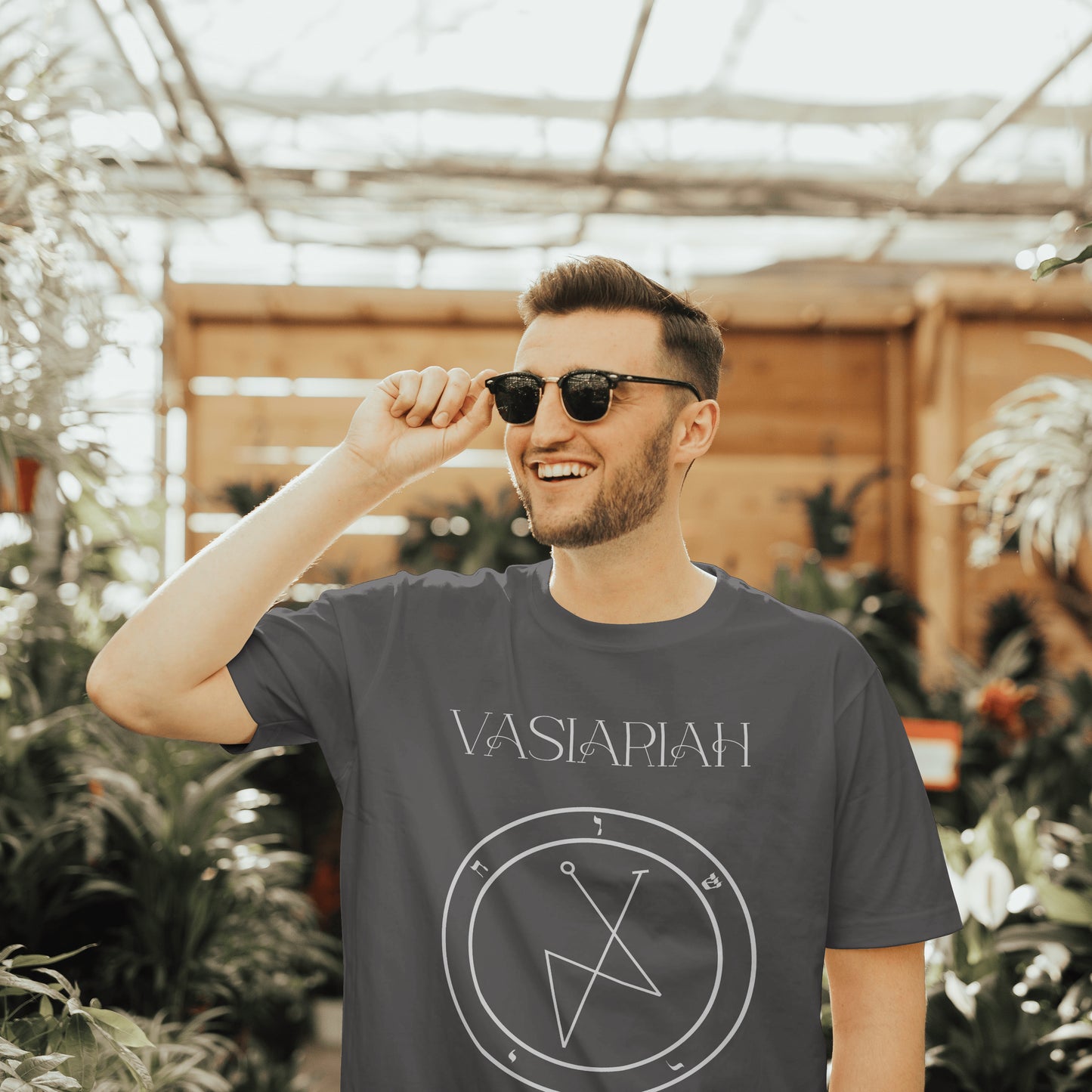 Model wearing No.32 Vasiariah Shem Hamephorash Guardian Angel T-Shirt in charcoal with symbol of Vasiariah on front.