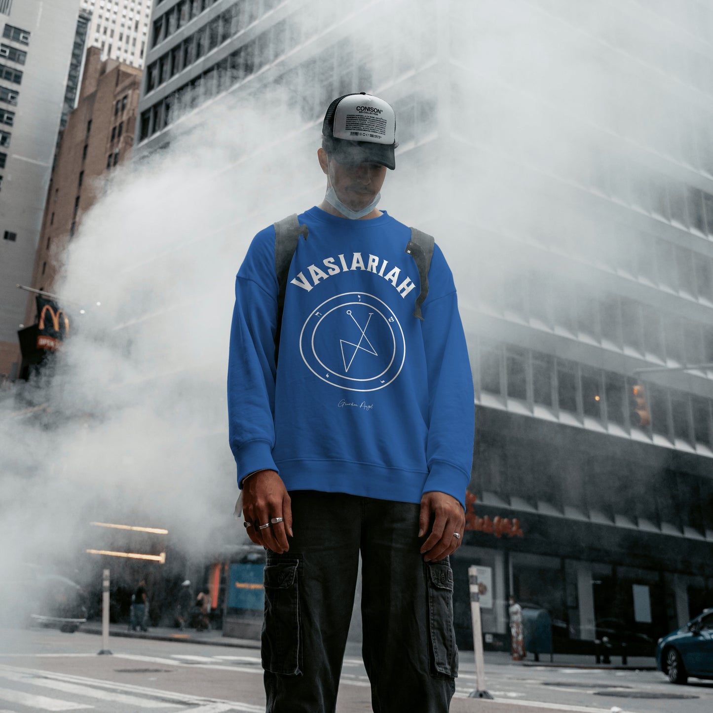 Model wearing a No.32 Shemhamphorasch Guardian Angel "Vasiariah" Sweatshirt in Royal Blue. With the seal of Vasiariah in white print on the front.