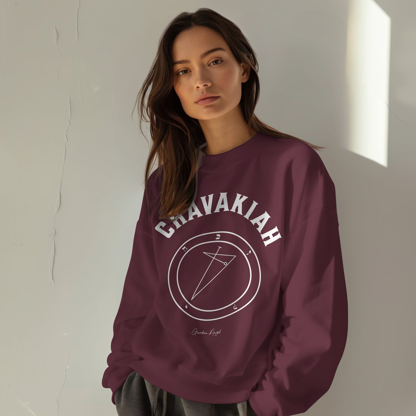 Model wearing a No.35 Shemhamphorasch Guardian Angel "Chavakiah" Sweatshirt in Maroon. With the seal of Chavakiah in white print on the front.