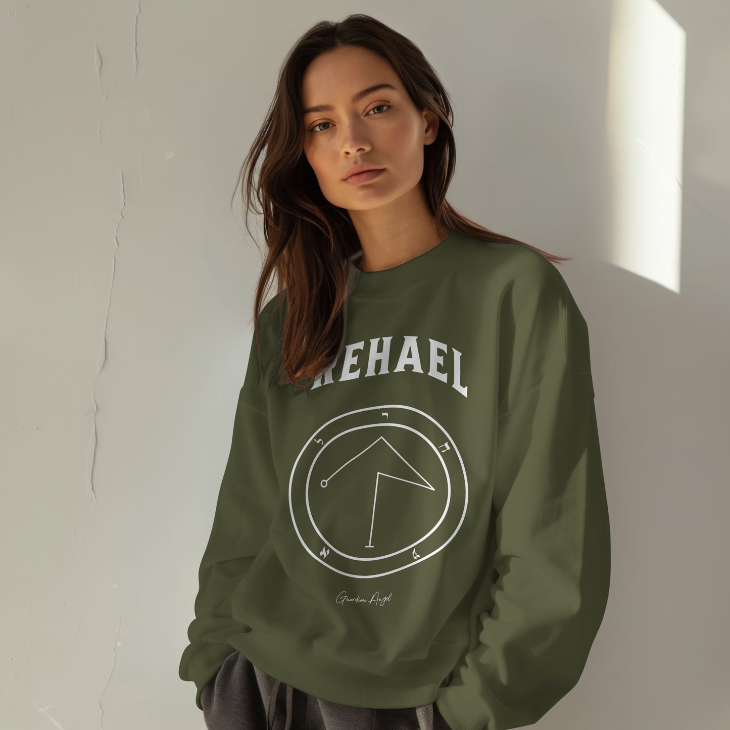 Model wearing a No.39 Shemhamphorasch Guardian Angel "Rehael" Sweatshirt in Military Green. With the seal of Rehael in white print on the front.