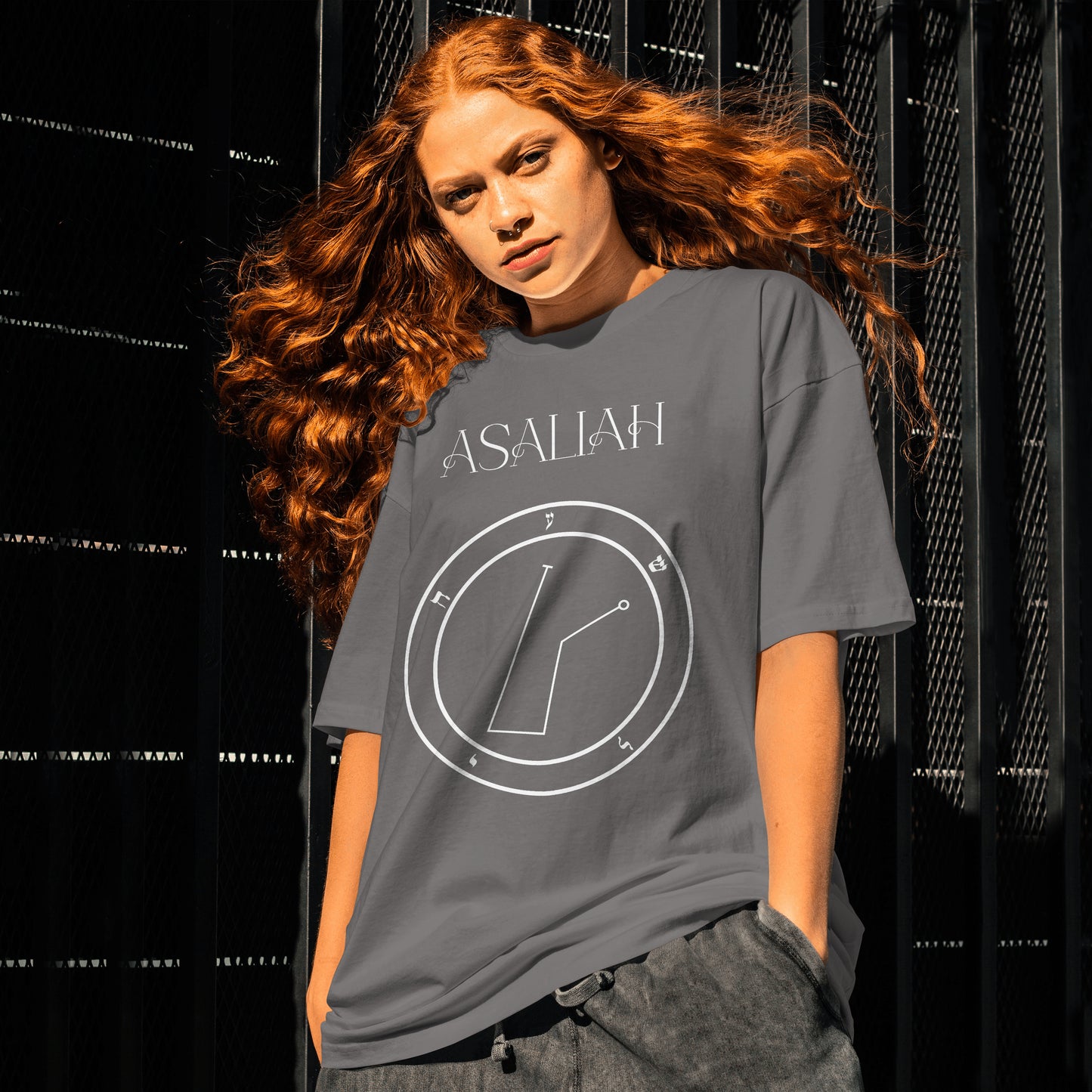 Model wearing No.47 Asaliah Shem Hamephorash Guardian Angel T-Shirt in charcoal with symbol of Asaliah on front.