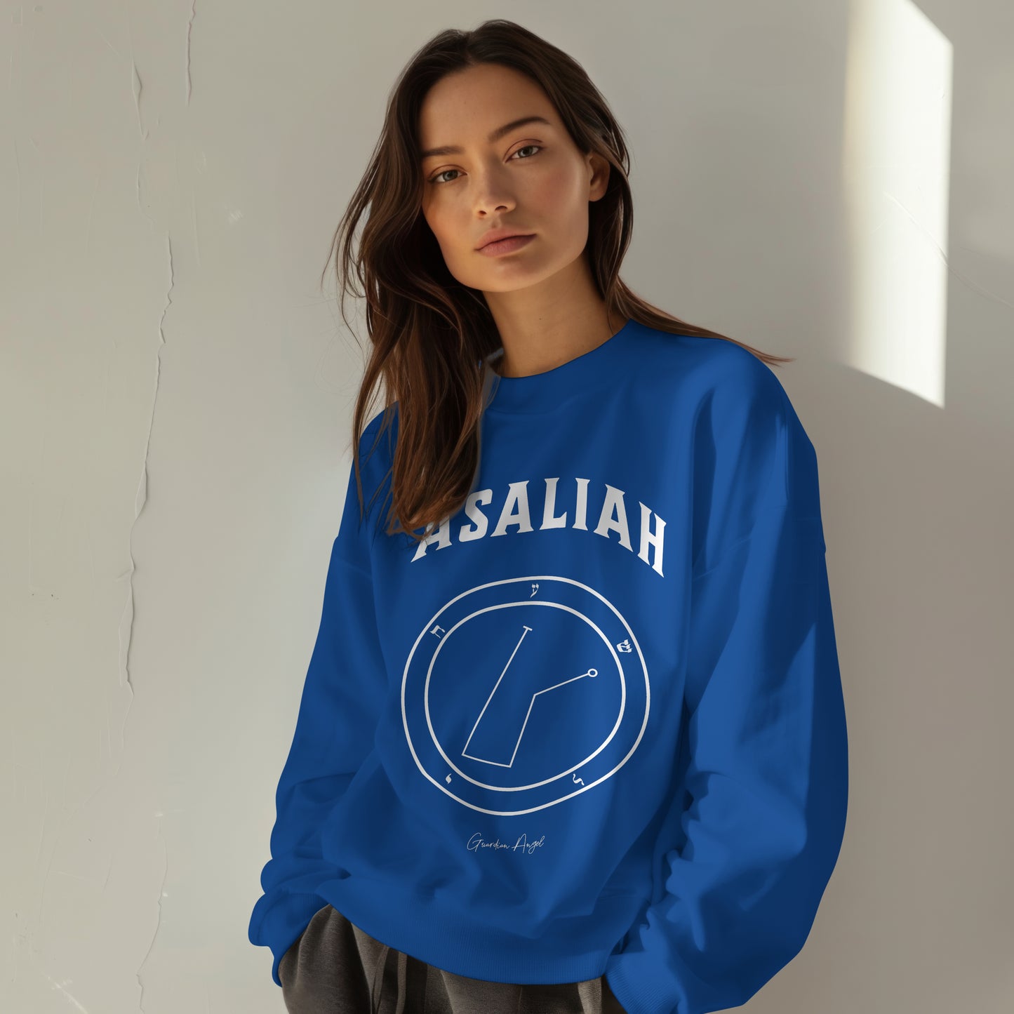 Model wearing a No.47 Shemhamphorasch Guardian Angel "Asaliah" Sweatshirt in Royal Blue. With the seal of Asaliah in white print on the front.