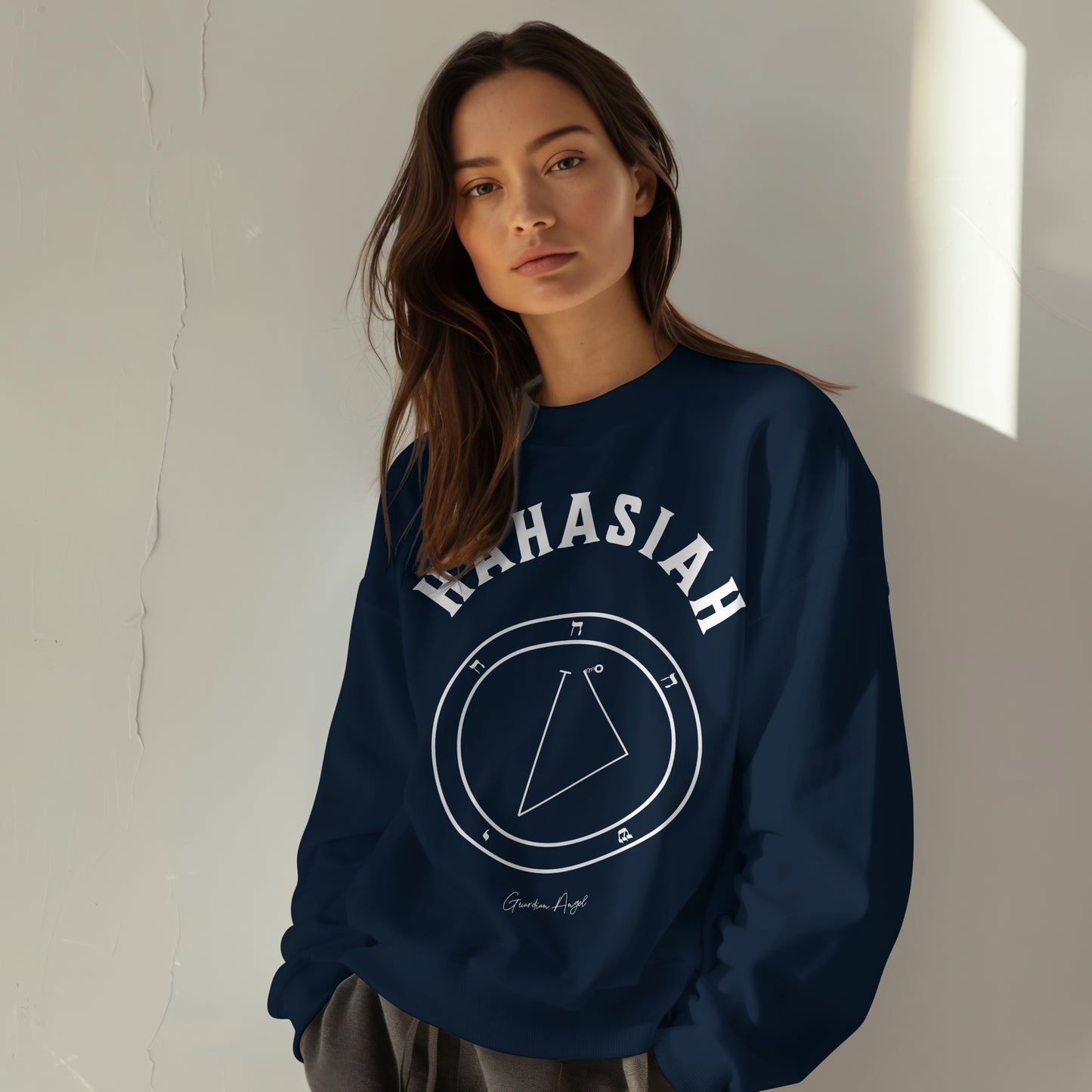 Model wearing a No.51 Shemhamphorasch Guardian Angel "Hahasiah" Sweatshirt in Navy Blue. With the seal of Hahasiah in white print on the front.