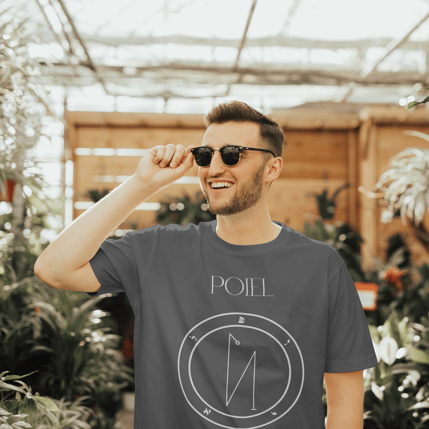 Model wearing No.56 Poiel Shem Hamephorash Guardian Angel T-Shirt in charcoal with symbol of Poiel on front.