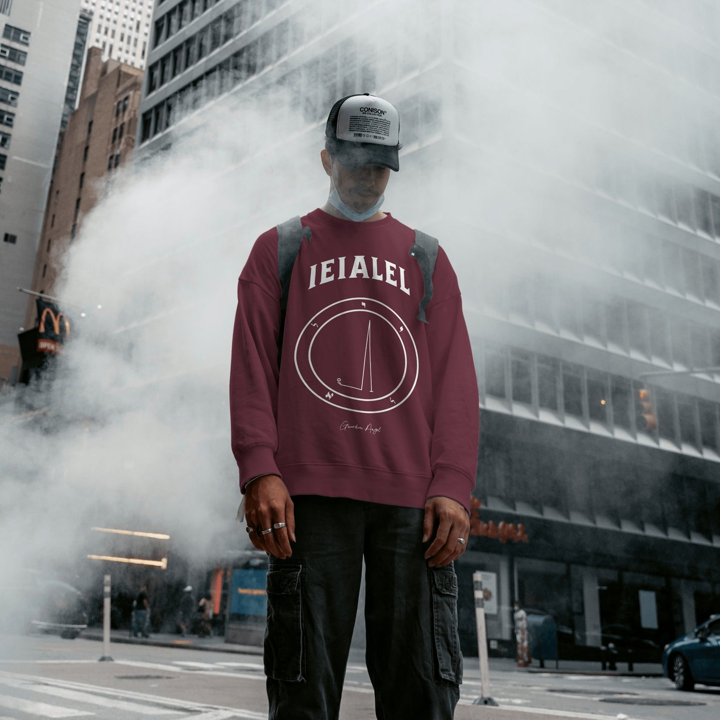 Model wearing a No.58 Shemhamphorasch Guardian Angel "Ieialel" Sweatshirt in Maroon. With the seal of Ieialel in white print on the front.