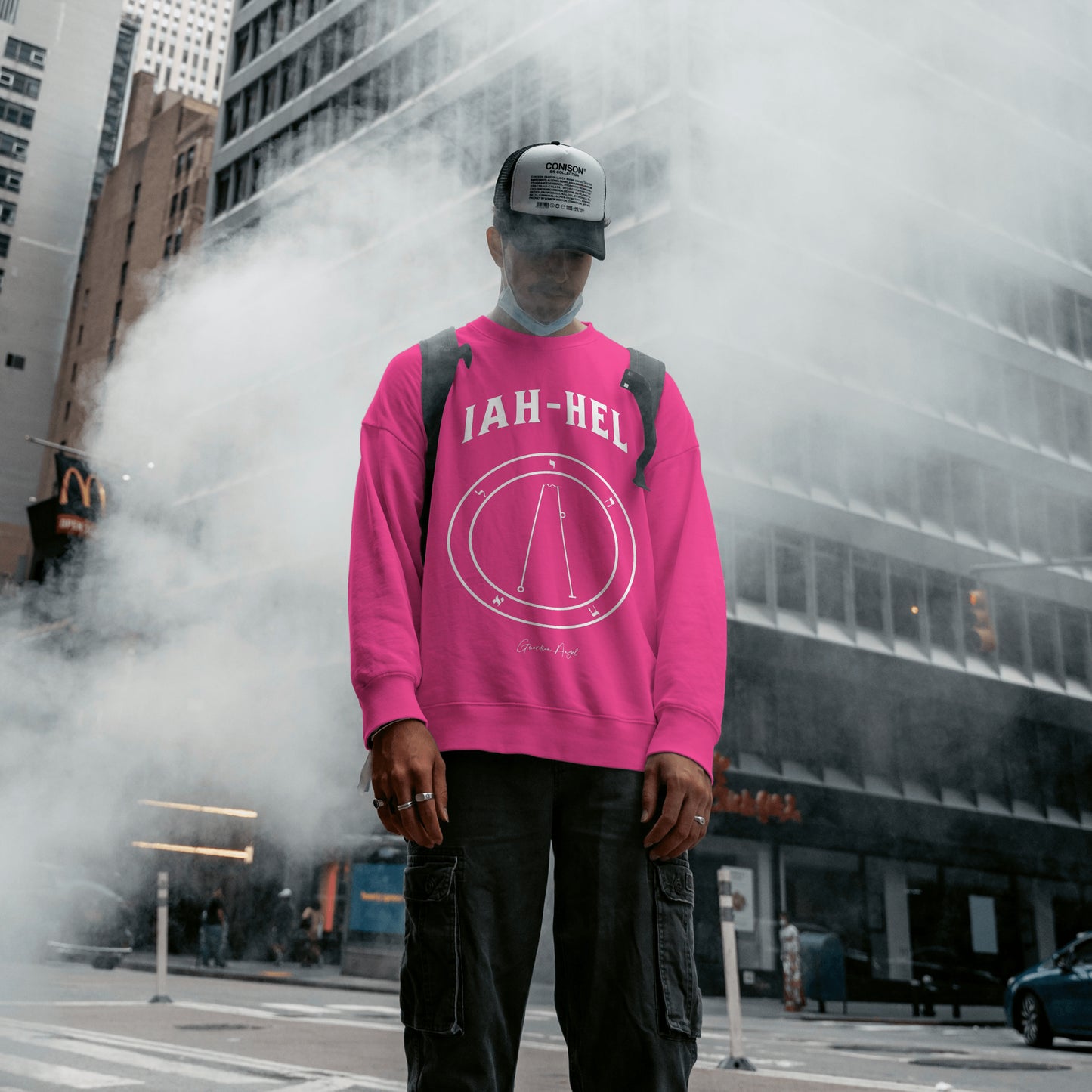 Model weating a No.62 Shemhamphorasch Guardian Angel "Iah-Hel" Sweatshirt in Heliconia Pink With the seal of Iah-Hel in white print on the front.