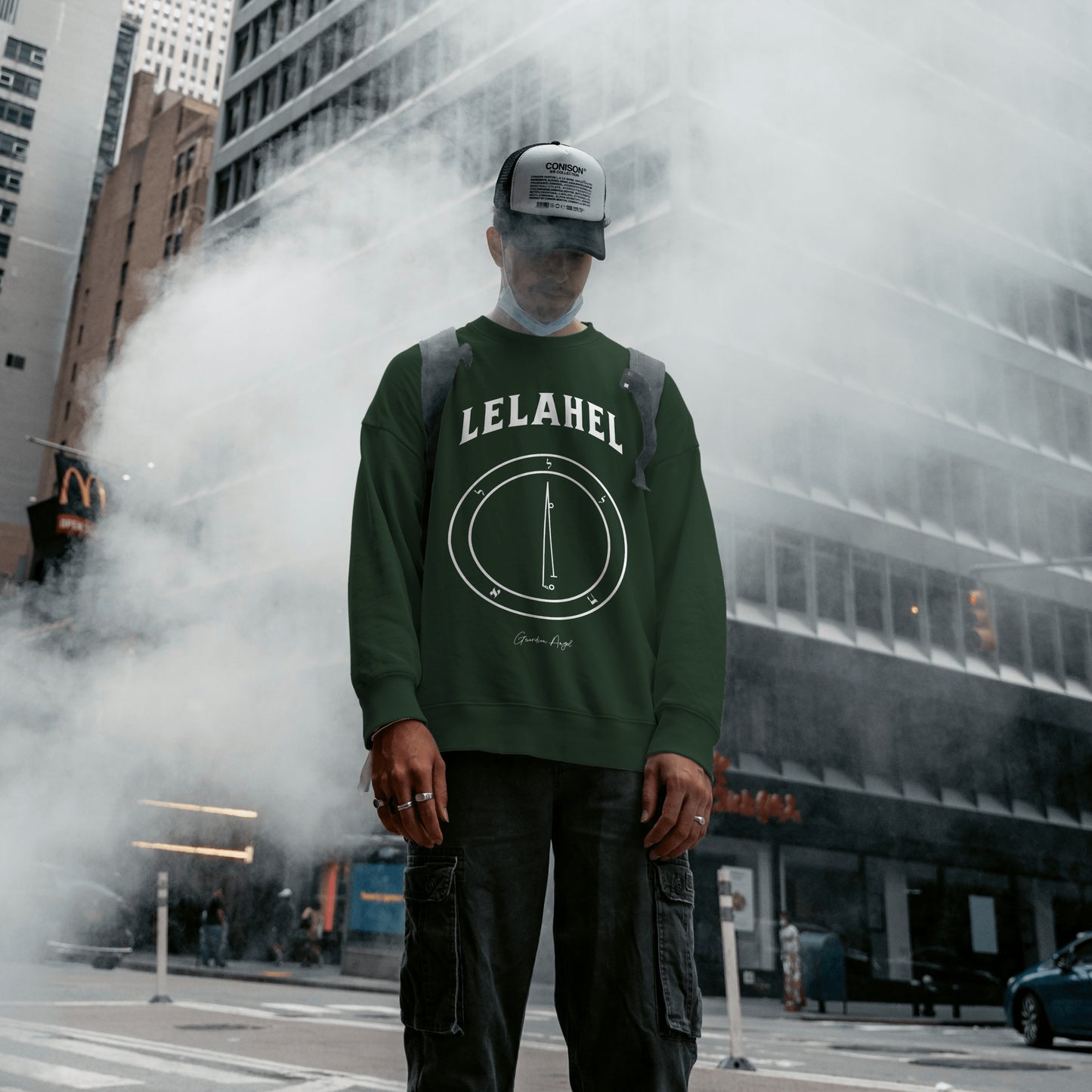Model wearing a No.6 Shemhamphorasch Guardian Angel "Lelahel" Sweatshirt in Forrest Green. With the seal of Lelahel in white print on the front.