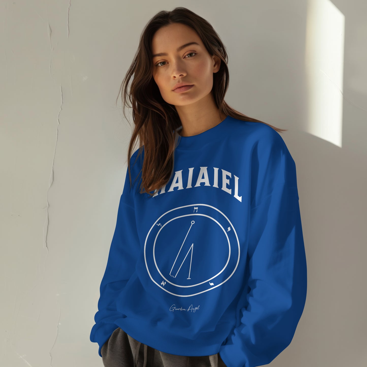 Model wearing No.71 Shemhamphorasch Guardian Angel "Haiaiel" Sweatshirt in Royal Blue . With the seal of Haiaiel in white print on the front.
