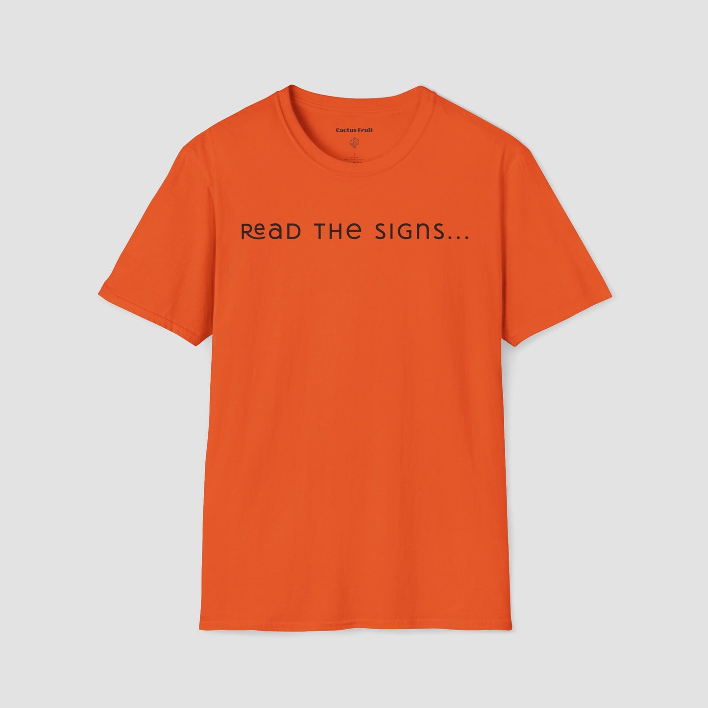 Orange t-shirt with 'READ THE SIGNS...' text on a light gray background