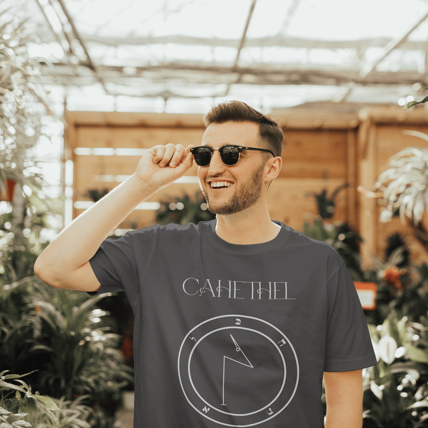 Model wearing No.8_Cahethel Shem Hamephorash Guardian Angel T-Shirt in charcoal with symbol of Cahethel on front.
