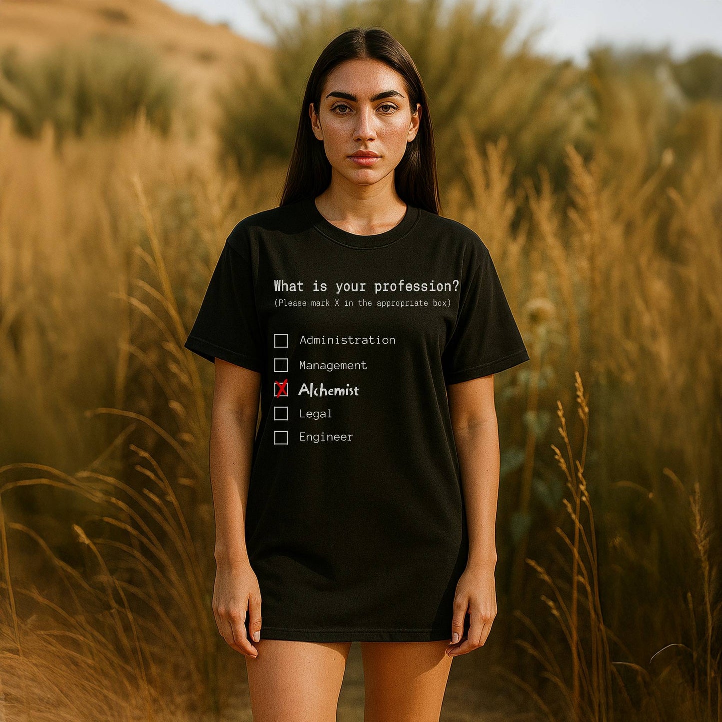 Person wearing a black t-shirt with a humorous profession quiz in a field