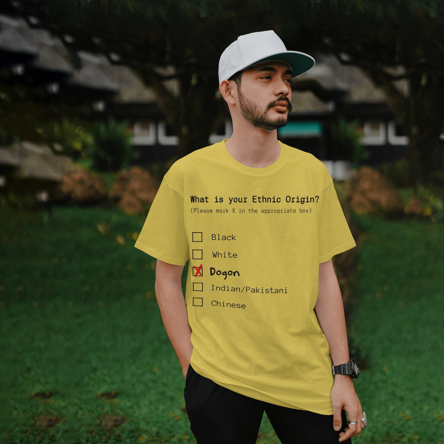 Man wearing a yellow t-shirt with an ethnic origin questionnaire in a garden setting