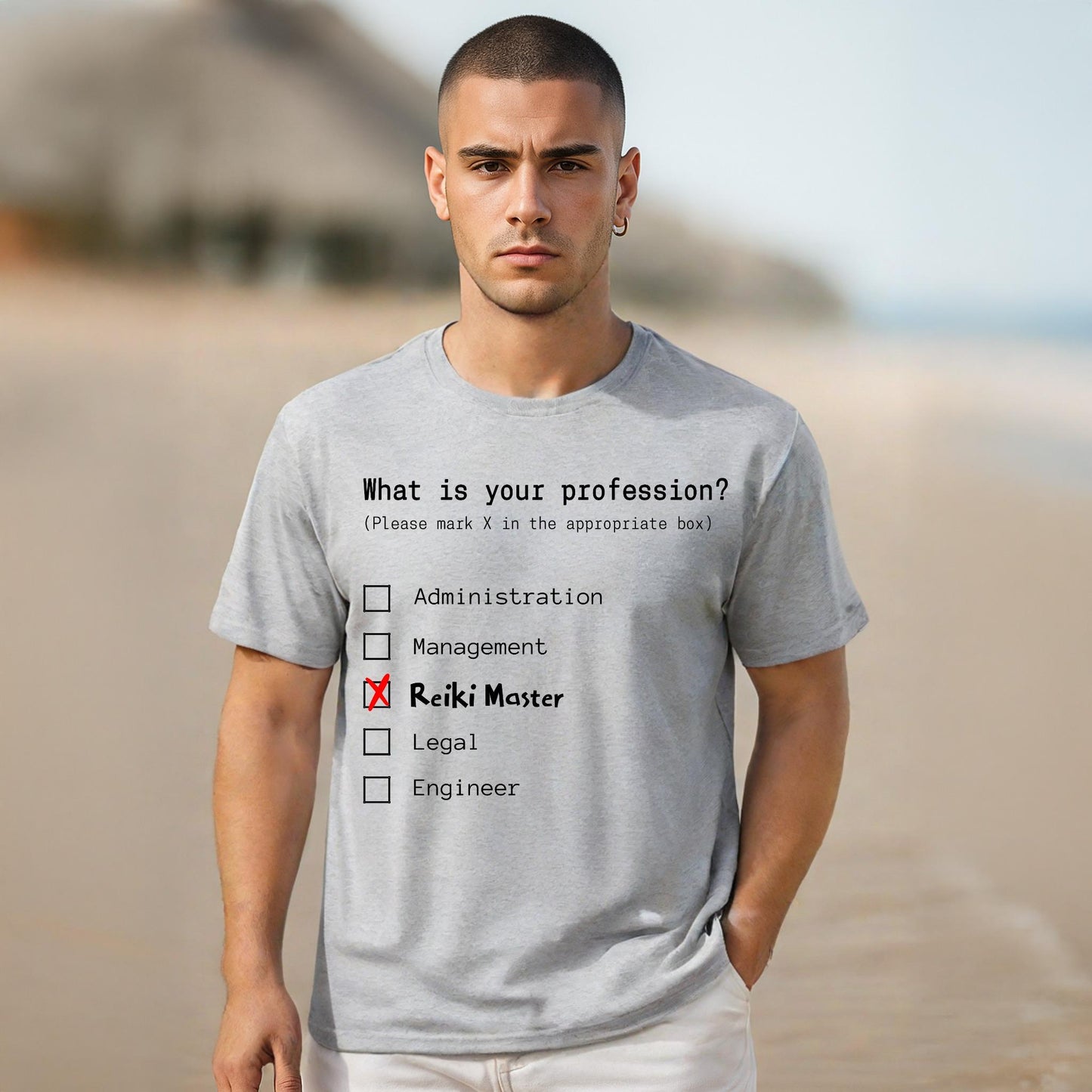 Man wearing a t-shirt with a humorous profession quiz on a beach