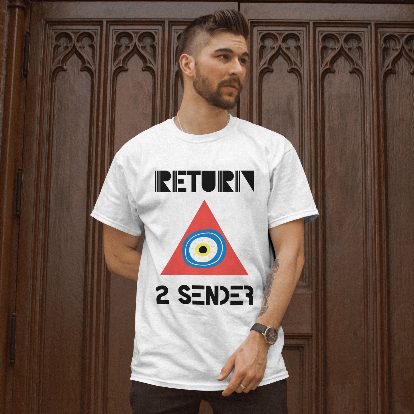 Model wearing a White T-shirt featuring the slogan Return 2 Sender with a large red triangle containing a round blue, white and yellow evil eye emblem in the centre.