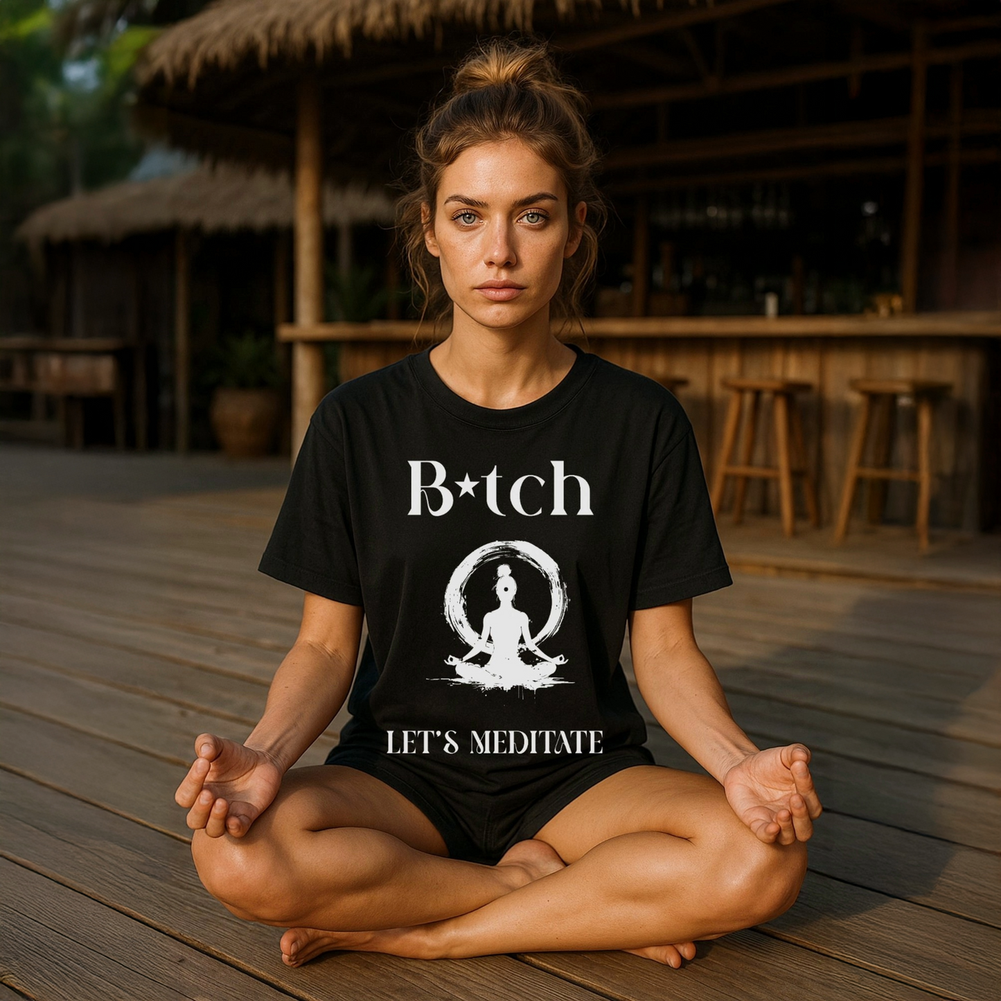 Model wearing a Black t-shirt with white silhouette of female sat in a Yoga pose and the words Bitch Let's Meditate.