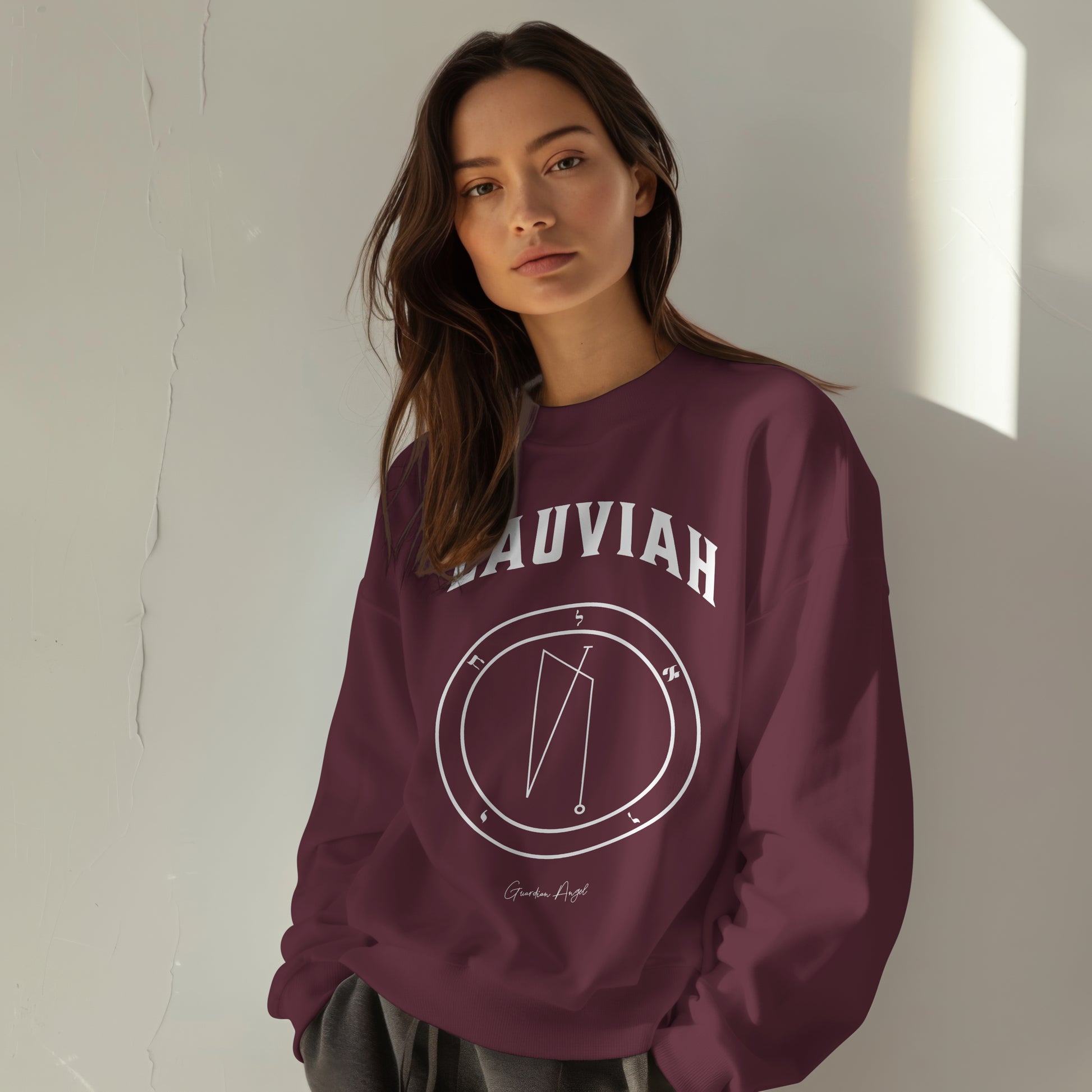 Model wearing a No.11 Shemhamphorasch Guardian Angel "Lauviah"  Sweatshirt  in Maroon. With the seal of Lauviah in white print on the front. 
