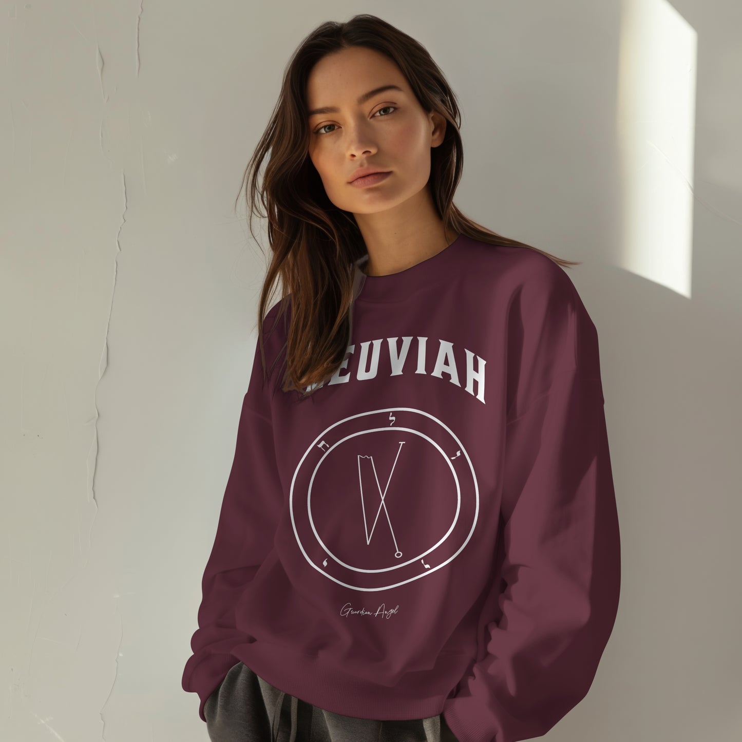 Model wearing a No.19 Shemhamphorasch Guardian Angel "Leuviah"  Sweatshirt  in Maroon. With the seal of Leuviah in white print on the front. 