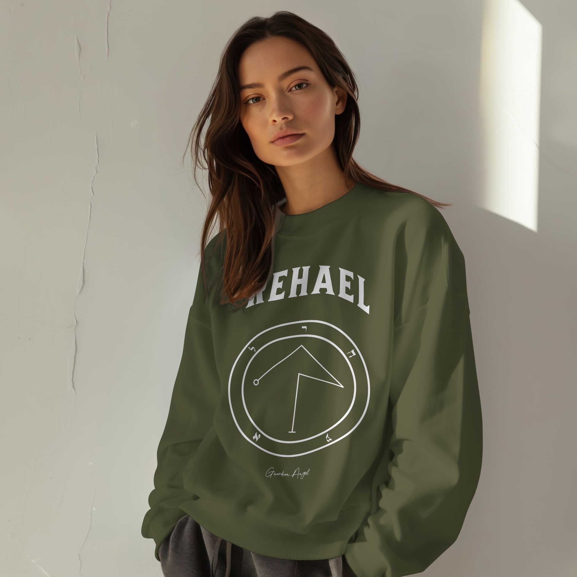 Model wearing a No.39 Shemhamphorasch Guardian Angel "Rehael"  Sweatshirt  in Military Green. With the seal of Rehael in white print on the front.