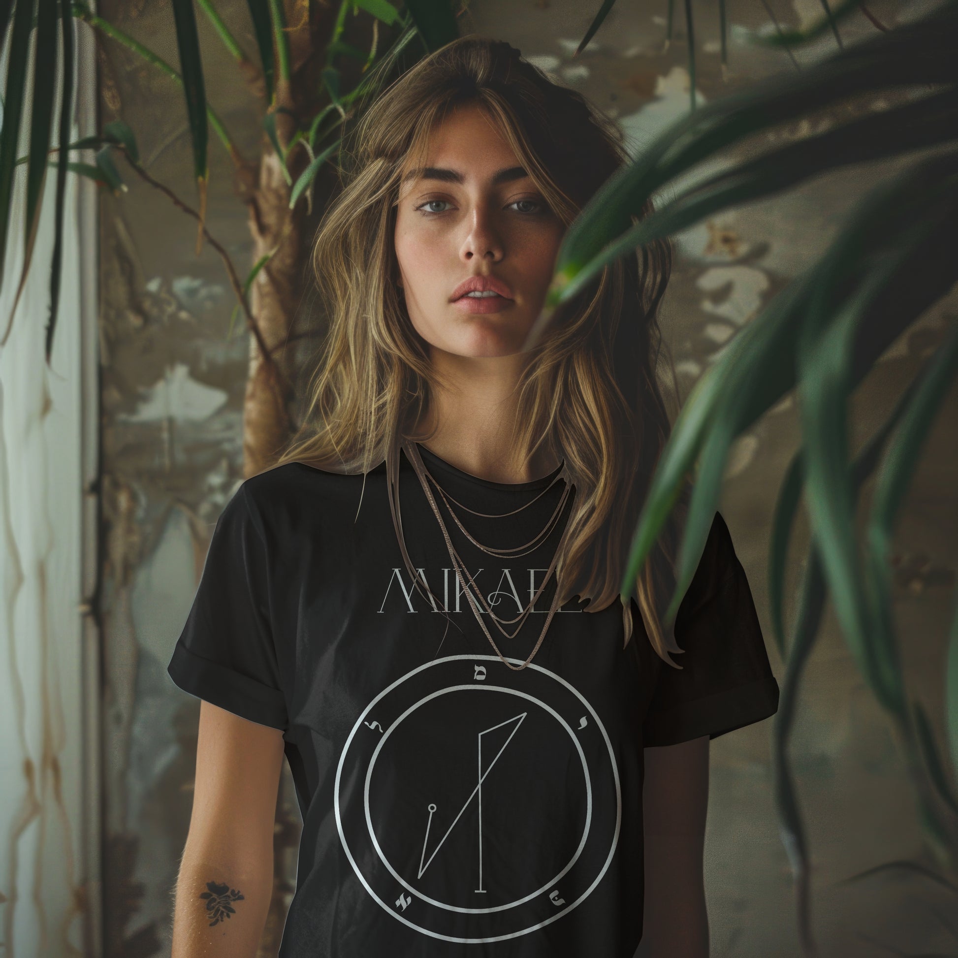 Model wearing No.42 Mikael Shem Hamephorash Guardian Angel T-Shirt in black with symbol of Mikael on front. 
