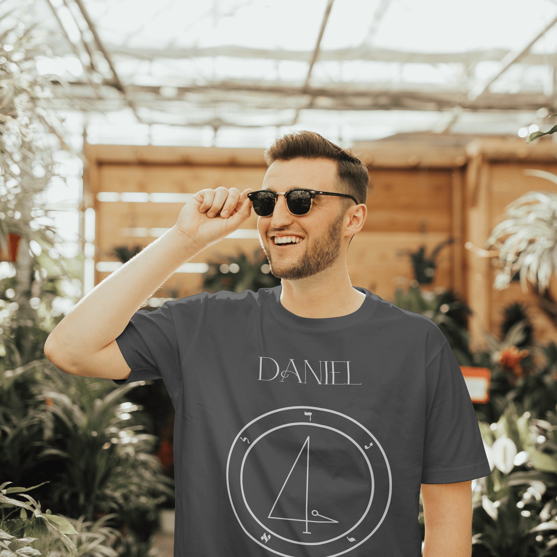 Model wearing No.50 Daniel Shem Hamephorash Guardian Angel T-Shirt in charcoal with symbol of Daniel on front.