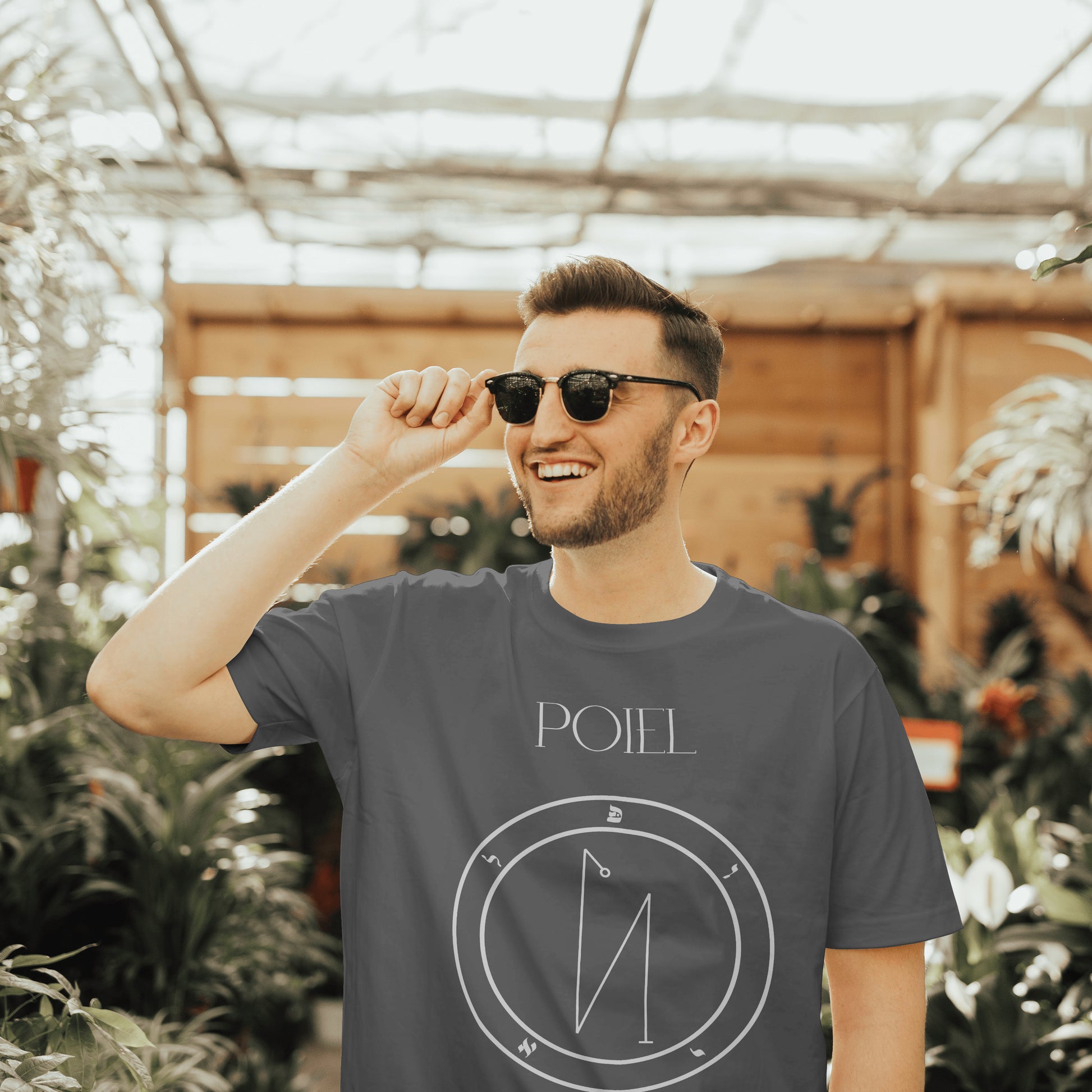 Model wearing No.56 Poiel Shem Hamephorash Guardian Angel T-Shirt in charcoal with symbol of Poiel on front. 
