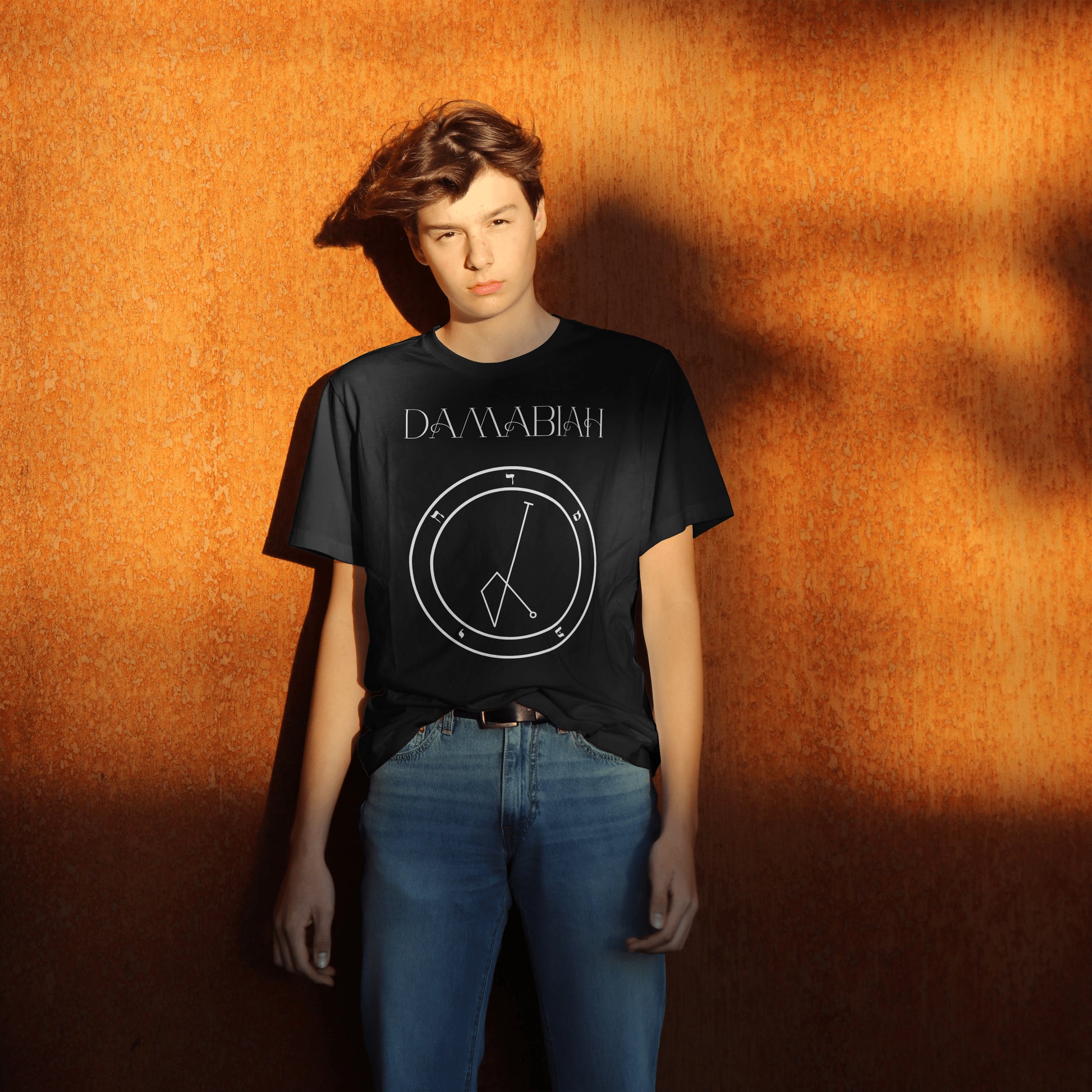 Model wearing No.65 Damabiah Shem Hamephorash Guardian Angel T-Shirt in black with symbol of Damabiah on front. 
