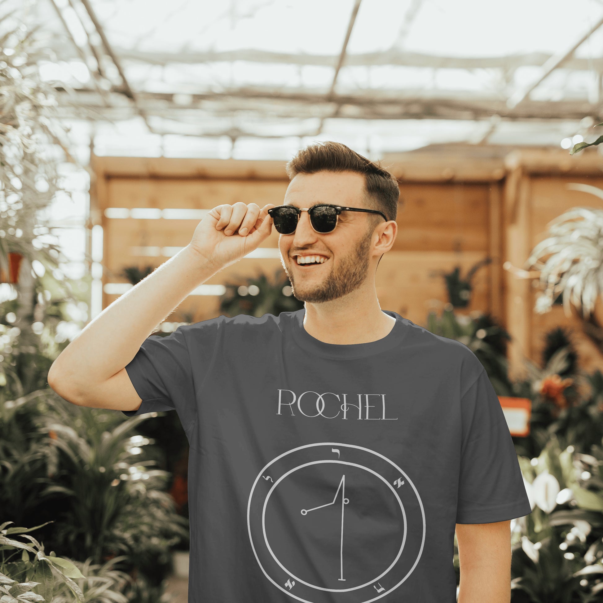 Model wearing No.69 Rochel Shem Hamephorash Guardian Angel T-Shirt in charcoal with symbol of Rochel on front. 