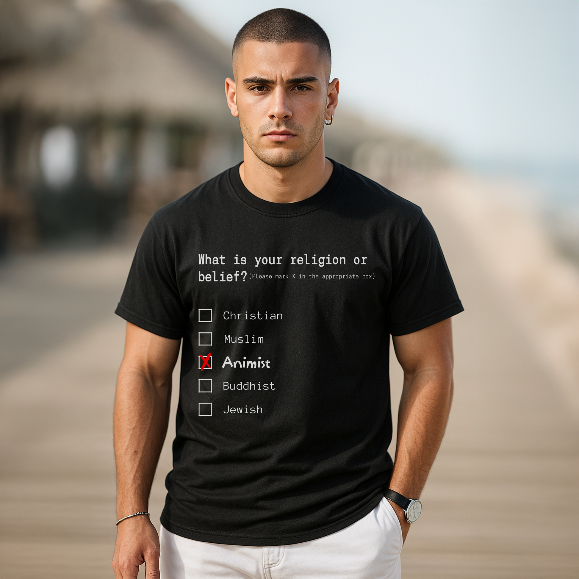 Man wearing a black t-shirt with a religious belief questionnaire on a blurred beach background